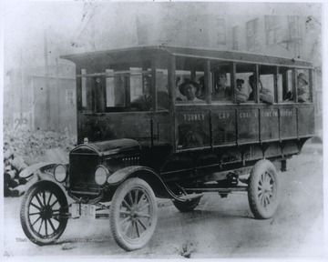 A group of miners sit inside the Ford bus that will take them to the Wenonah Mine. 