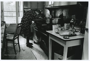 Mrs. Howard prepares a meal for guests at the hotel.