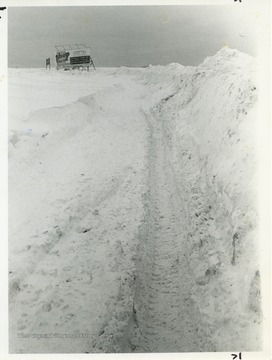 Piles of snow line the highway after a heavy storm.