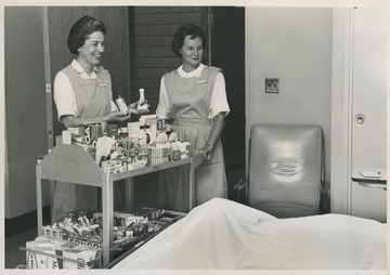 Two women offer snacks and other items to patients at the WVU Hospital. Friends of University Hospital is a non-profit organization that promotes the health and welfare of individuals in the Morgantown community. 