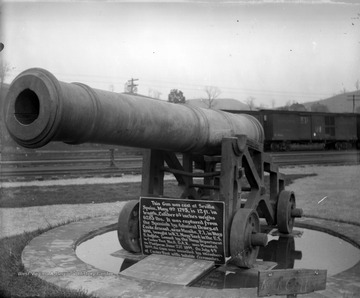 The Grand Army of the Republic, or G.A.R., was a fraternal organization composed of veterans of the Union Army, Union Navy, Marines and the U.S. Revenue Cutter Service who served in the American Civil War for the Northern/Federal forces. Its peak membership, at more than 490,000, was in 1890, a high point of various Civil War commemorative and monument dedication ceremonies. It was succeeded by the Sons of Union Veterans of the Civil War, composed of male descendants of Union Army and Union Navy veterans.The G.A.R. was organized into "departments" at the state level and "posts" at the community level. This old artillery gun monument was dedicated by the G.A.R. Department of West Virginia, Custer Post No. 8.The plaque beneath the gun reads, "This gun was cast at Sevilla Spain, May 9th 1795, is 12 ft. in length, Caliber 6 3/8 inches weighs 6283 lbs. It was captured from the Spanish by Admiral Dewey, at Cavite Arsenal, near Manila, P.I. [Philippines] in May 1898, brought to N. Y. Navy Yard in the U. S., S. Buffalo [South Buffalo, New York]. Loaned by the Navy Department to Custer Post No. 8 G.A.R. was Mounted on Platform June 23rd, 1899. On July 4th, 1899, the Gun was unveiled by members of Custer Post with suitable ceremonies."