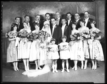 The Silling-Ziler wedding party gathers for a group portrait in the Gravely and Moore Photography Studio.