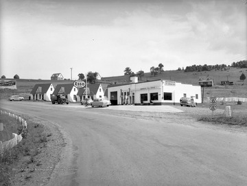 Three cabins sit to the left of an Esso gas station, located on West Virginia State Routes 33 and and 220.