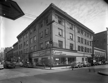 The Knights Building hosts a variety of businesses, including Carson's Millinery, Household Finance Loans, Richman Bros. Clothes, The Baby Shop, The Loop Restaurant, and Capital Plan Loans.