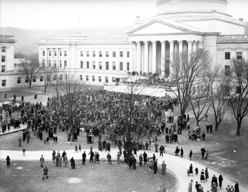 A large crowd is gathered outside of the state building, likely for an inauguration of some sort. 