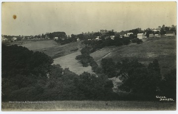 Houses are scattered at the top of hill.