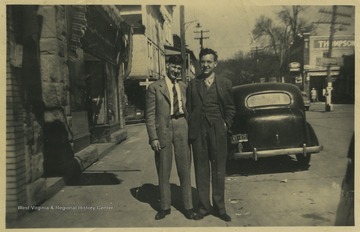 Hardman, left, and Hathaway, right, pose together by the street. In the background is Thompson Drug Co.