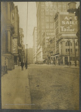 A man walks down the sidewalk alone on the left.This photograph is found in a scrapbook documenting the survey for the Baltimore and Ohio Railroad in West Virginia and surrounding states. 