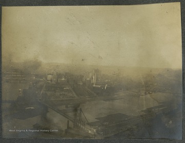 Cityscape of Pittburgh, looking from Mt. Washington.This photograph is found in a scrapbook documenting the survey for the Baltimore and Ohio Railroad in West Virginia and surrounding states. 