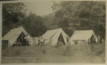 Surveyors for the B. & O. Railroad set up camp by the Carnifax Ferry.This photograph is found in a scrapbook documenting the survey for the Baltimore and Ohio Railroad in West Virginia and surrounding states. 