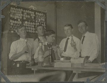 Group portrait of Baltimore and Ohio Railroad engineers.This photograph is found in a scrapbook documenting the survey for the Baltimore and Ohio Railroad in West Virginia and surrounding states. 