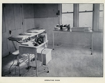 View of operating room in hospital, outfitted with medical equipment and surgical supplies.