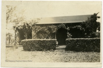 From reverse: "This is a small unpainted home in Harrison County, W. Va. but isn't it an attractive little nest? These people could not afford to build a better home when this house was built but Mrs. N. said she wanted her children to remember such 1."