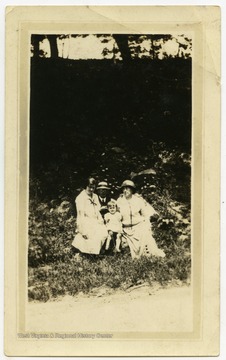 Portrait of the Harper family.  Pictured are Charles and Loretta, parents, Carrie Harper, daughter, and Mary Alice, Carrie's daughter.