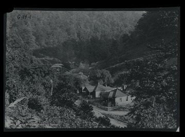 Several houses along a road in the valley.