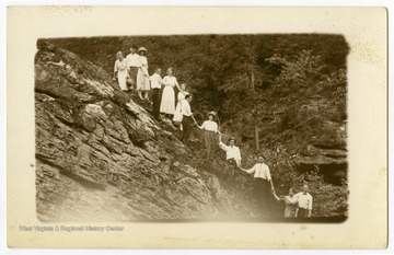 A group of young men and women pose on a rocky hillside near the Cheat River, W. Va.