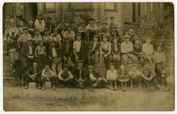 A large group of male glass workers, primarily children or young adults.