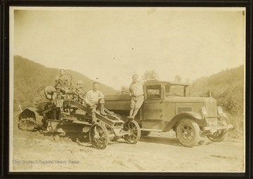 Equipment on the left is a road grader, which would smooth out a road surface.