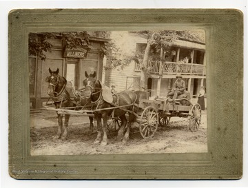 Wagon is in front of Thompson Sisters Milliners storefront.