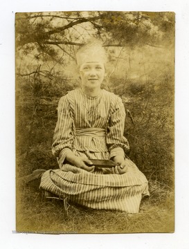 The girl is wearing a paper crown, likely for a birthday or other special occasion.