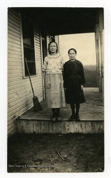 Back of photo reads: "Bessie and Vernie, taken on the porch of the school house."