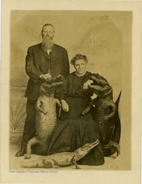 Harvey and Narcissus Trail pose with stuffed alligators in Jacksonville, Florida.