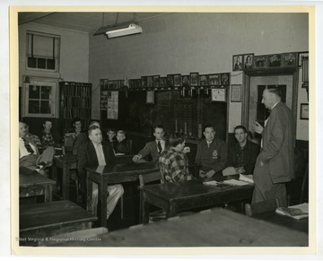 R.J. Friant, Extension agronomist, WVU, discussed the results of the 1955 contest at Vo-ag Room, Clay High School, where second place award was given to Howard Fitzwater.