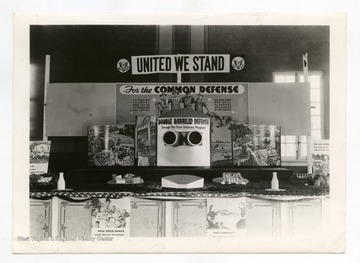 Signs read: "For the Common Defense. Six Million Farmers have united to strengthen the nation. We have food and soil reserves unequaled in the world and Double Barreled Defense through the Farm Defense Program."