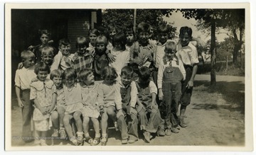 Students at the Fort Martin School pose for a group photograph. Pictured are an unidentified Everly child, Vergie Johnson, Juanita Thomas, Mildred Johnson, Loretta Johnson, Philip Hunt, Chas Hennen, John Herod, John Smith, John Johnson, Frances Thomas, Glenna Gribble, Lois Parker, Earl McCord, Elmore Thomas, Lemuel John, Morton VanVoorhis, Edward Thomas, Pearl McCord, Ruth Stadlbauer, Jessie Darling, and Chas Parker.