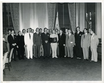 Pictured left to right are:First Row: Karl R. Bendetsen, Msgr. Howard J. Carroll, Louis Johnson, Charles E. Wilson, Maurice J. Tobin, Harry S. Truman, Vice Adm. Ross T. McIntire, Oscar R. Ewing, John J. Sparkman, George Barr, Ralph Wright.Second Row: Gen. Harry H. Vaughan, Robert T. Creasey, Dr. Howard Rusk, Joseph C. Dunn, Philip Kaiser, Francis P. Whitehair, Lt. Gen. Graves B. Erskine, Roswell L, Gilpatric, Michael J. Galvin, Eric Johnston, Earl H. Gammons, Theodore Marks.