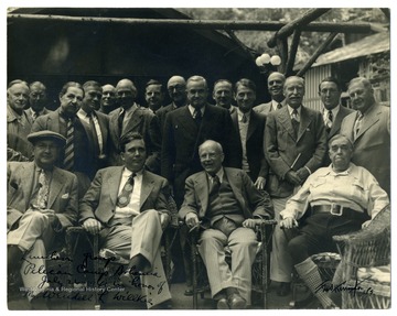 A group portrait of those attending a luncheon honoring Mr. Wendell L. Willkie, the 1940 Republican nominee for the presidency, at Pelican Camp, part of the Bohemian Grove complex in California. Louis Johnson, later Secretary of Defense, is pictured seated on the far left, next to Willkie. 