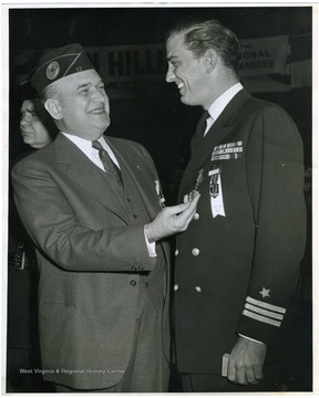 Louis Johnson congratulates a fellow American League member at the national convention.