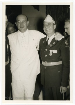 Louis Johnson, at that time Assistant Secretary of War, is pictured with a member of the Arkansas American Legion at an event at which he gave a speech.