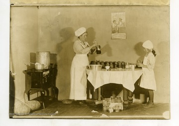 Cunningham, Assistant Home Demonstration agent, instructing a club girl how to pack her exhibit to bring in to the fair without breaking.