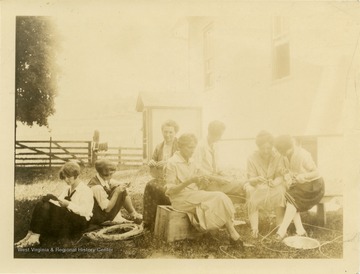 The women are weaving baskets.