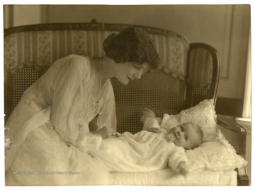 The woman is believed to be Ruth Maxwell Johnson, wife of Louis Arthur Johnson, with one of her daughters in the early 1920s.