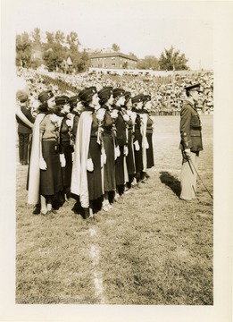 Female ROTC group gathered on football field.