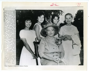 Caption reads, "Pearl Buck, the only woman ever to win both the Pulitzer and Nobel prizes in literature, poses with her four adopted daughters at her home in Perkasie, Pa. They are, from left, Cheico, 16; Johanna, 15; Henriette, 18; and Theresa, 17. Henriette is of German-American origin, the other three of Japanese-American origin. The thing closest to the 73-year-old author's heart is the foundation named after her. Its purpose is to raise $10 million to care for some 300,000 unwanted children fathered by American soldiers."