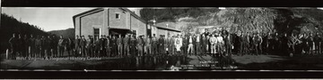 Night Force workers at the Crichton No.4 mine stand lined up in their work gear.