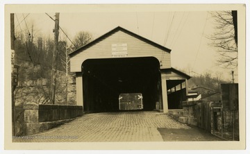 Placard reads, "Built by Eli and Len Chenoweth, 1852. Repaired by State Road Commission, 1934. C. A. Short, Bridge Supt."