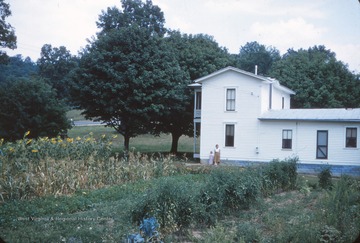 Pictured standing by the house are Barbara Borror Warden and her daughter Janet Warden Hawes.