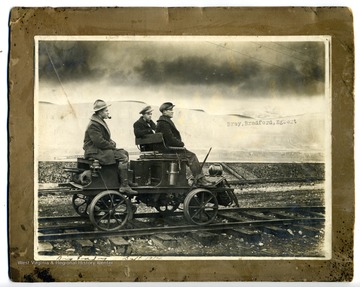 The three men are identified left to right as Sam F. Bray, Slim Bradford, and Egbert. They are members of the U. S. Army Corps of Engineers.