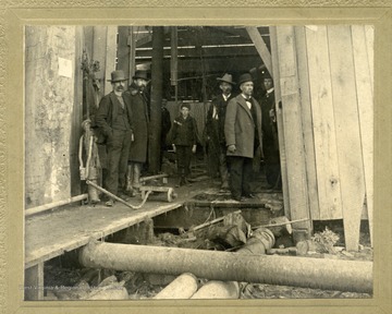 Mr. Isaac M. Kelley is pictured right, in the light overcoat. He was a West Virginia state mine inspector.