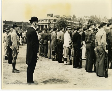 Caption on back of photo reads: "The Deacon" surveys. Bayard Young, Chemistry Building, W.V.U., Morgantown, West Virginia.