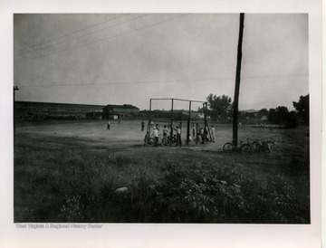 Onlookers watch from behind the fence for safety.