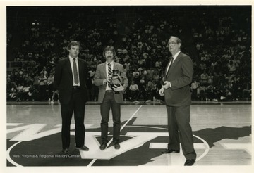 Rene Henry (R) presenting the Southland Olympia Award to WVU's Olympic Gold Medal Shooter, Edward Etzel.