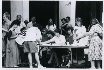 A group of people signing letters at the Block Bork Protest.