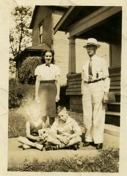 Charles Harper pictured far right. Other individuals are unidentified.