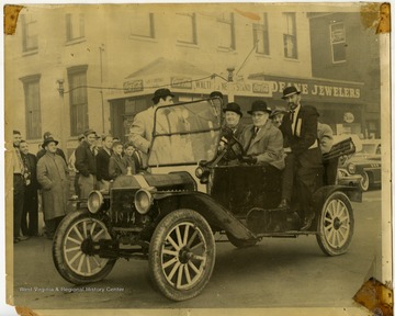 Sam Angotti drives several unidentified men in his vintage automobile.