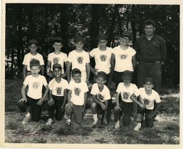 Coach Pete Rossetti alongside the players of his Little League baseball team in Morgantown.